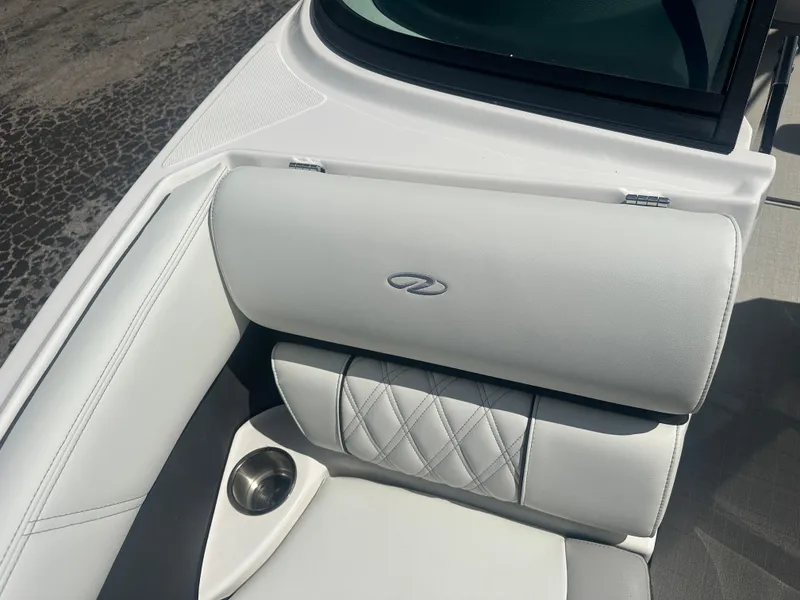 Slide: The Image of 2023 Regal 21 OBX boat interior with white cushioned seating and cup holder. - 17