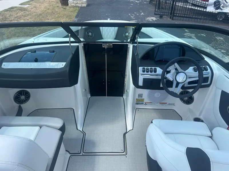Slide: The Image of 2023 Regal 21 OBX boat interior with modern dashboard and seating. - 21