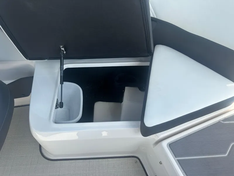 Slide: The Image of 2023 Regal 21 OBX boat storage compartment with open lid, showcasing interior space. - 28