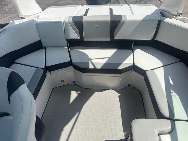 Slide: The Image of 2023 Regal 21 OBX boat interior with white and black cushioned seating. - 29