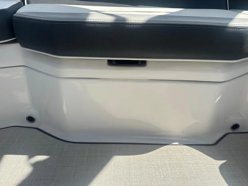 Slide: The Image of 2023 Regal 21 OBX boat interior seating with black and white upholstery. - 30