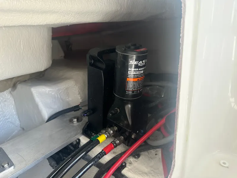 Slide: The Image of 2023 Regal 21 OBX boat engine compartment with hydraulic system and wiring. - 33