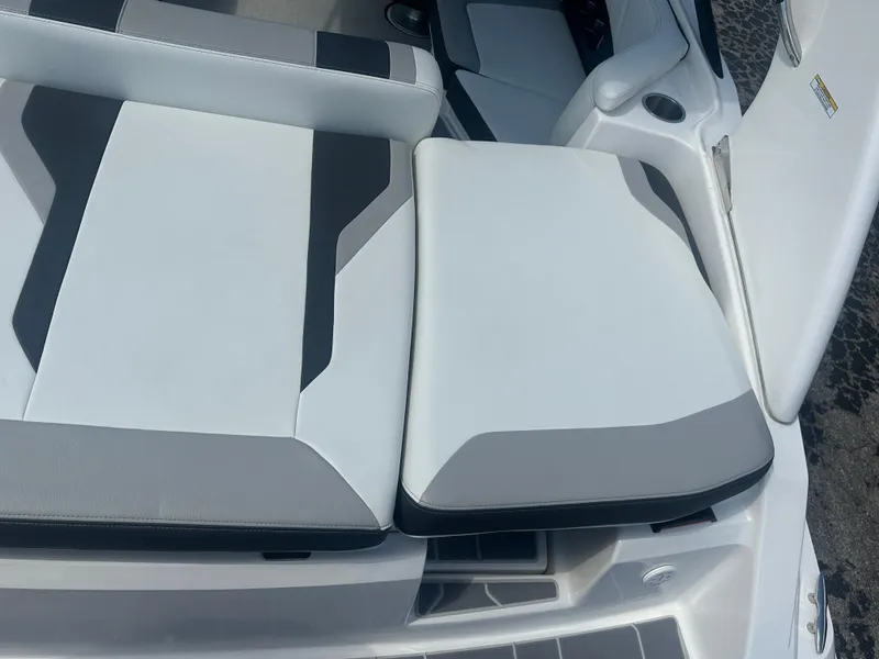 Slide: The Image of 2023 Regal 21 OBX boat seating with sleek, modern design in white and gray tones. - 35