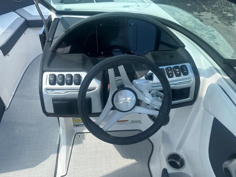Slide: The Image of 2023 Regal 21 OBX boat dashboard with steering wheel and control panel. - 36