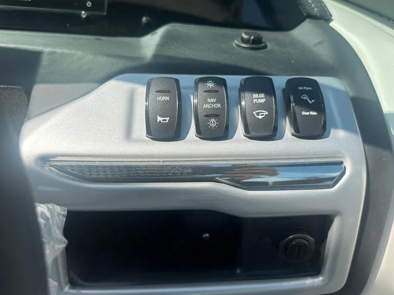 Slide: The Image of Control panel of 2023 Regal 21 OBX boat with labeled switches. - 39