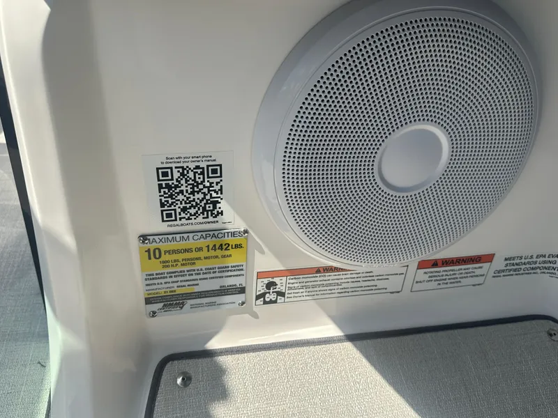 Slide: The Image of 2023 Regal 21 OBX boat interior with speaker, QR code, and capacity label. - 40