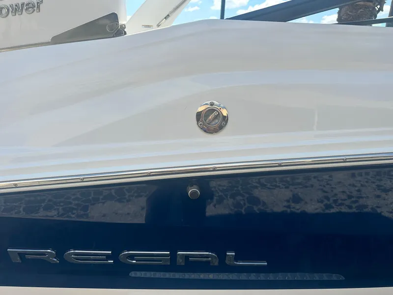 Slide: The Image of 2023 Regal 21 OBX boat side view with logo and sleek design. - 47