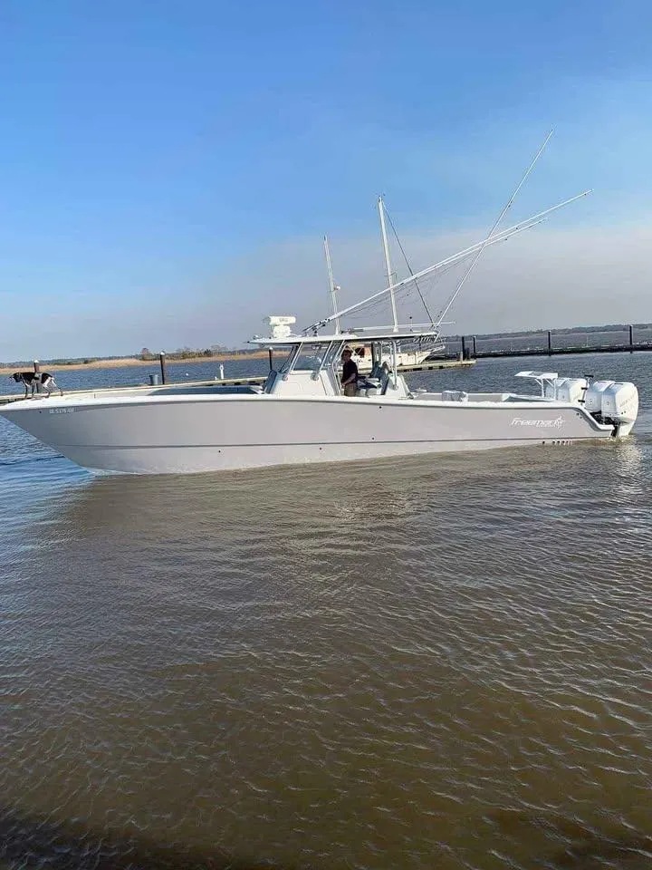 Slide: The Image of 2020 Freeman 42 LR boat on calm water with clear blue sky. - 13