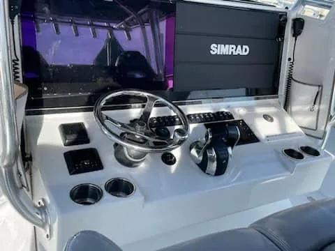 Slide: The Image of Freeman 42 LR 2020 boat dashboard with Simrad navigation system and steering wheel. - 18