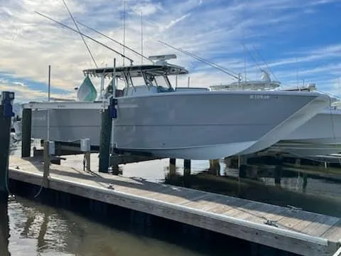 Slide: The Image of 2020 Freeman 42 LR boat docked at marina under blue sky. - 19