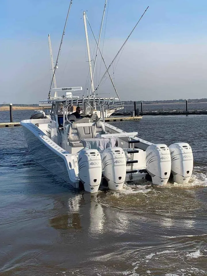 Slide: The Image of 2020 Freeman 42 LR boat with four powerful outboard engines on the water. - 2