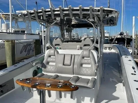 Slide: The Image of 2020 Freeman 42 LR boat with seating and rod holders, docked at a marina. - 20