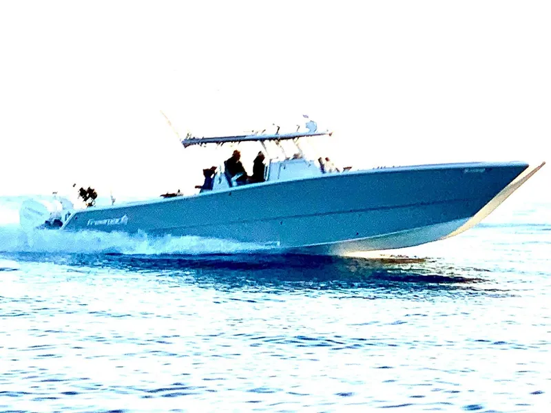 Slide: The Image of 2020 Freeman 42 LR boat cruising on open water. - 27