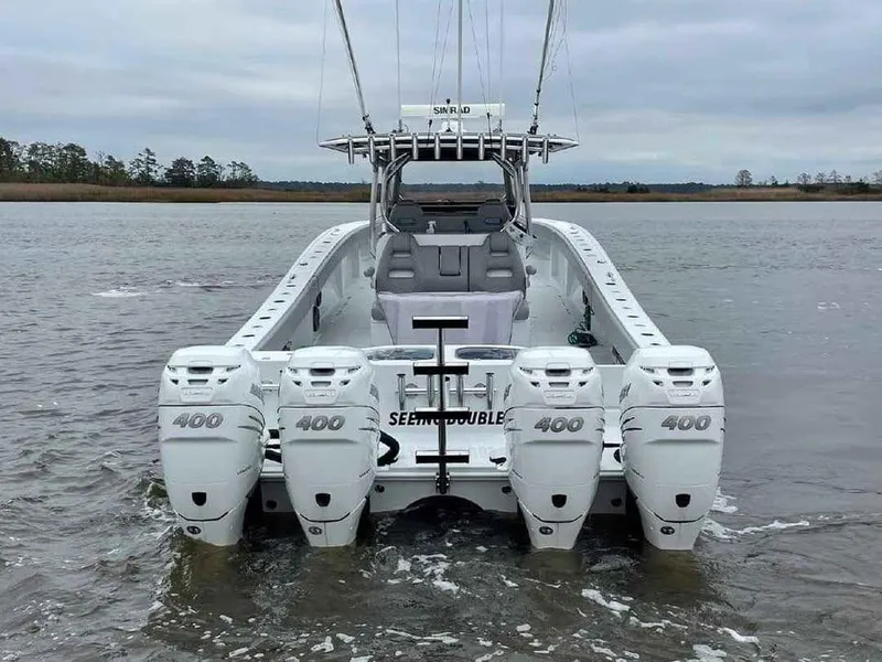 Slide: The Image of 2020 Freeman 42 LR boat with four 400 horsepower engines on a calm waterway. - 3