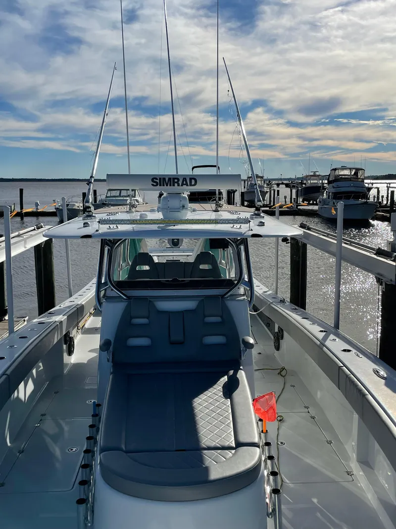 Slide: The Image of 2020 Freeman 42 LR boat docked, featuring Simrad equipment, under a partly cloudy sky. - 33