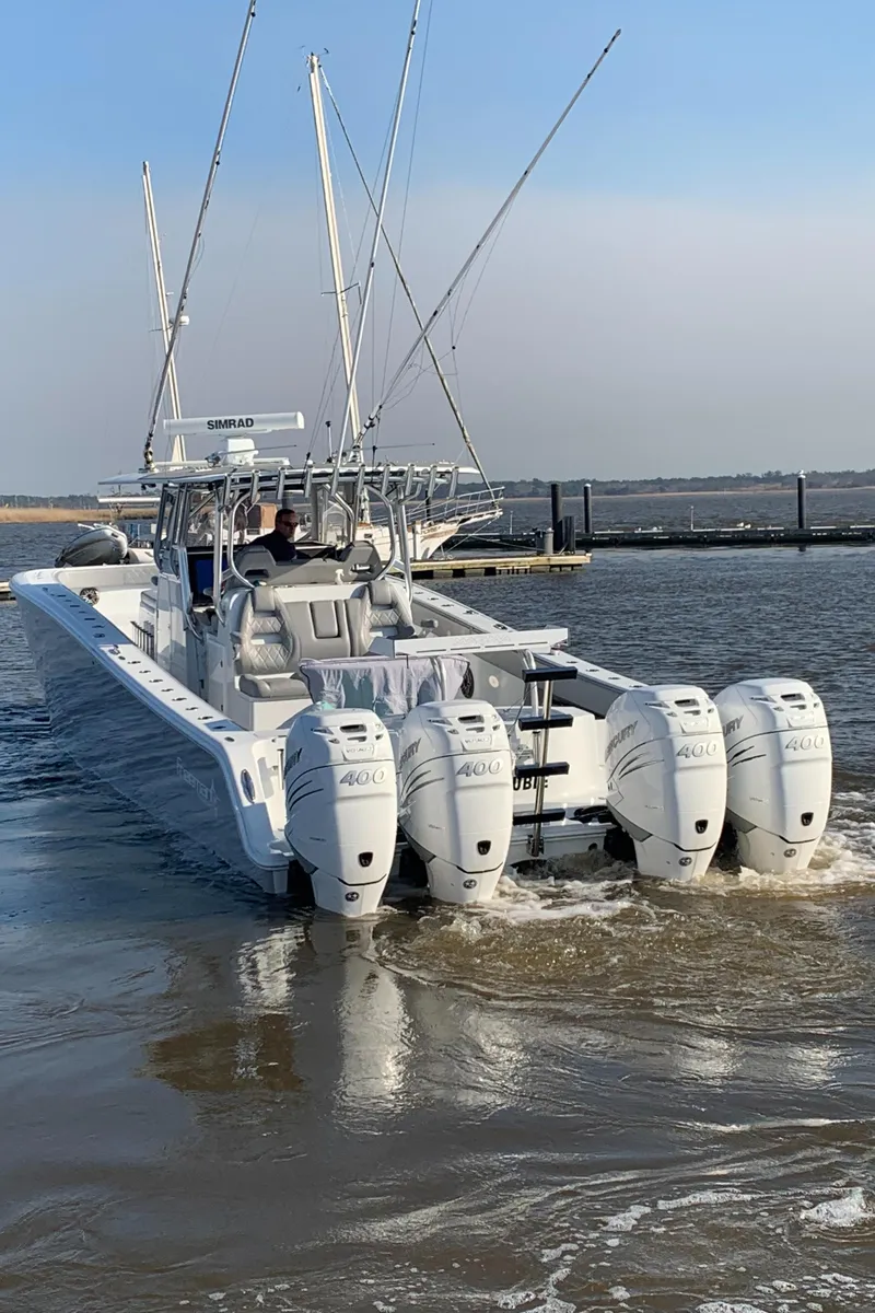 Slide: The Image of 2020 Freeman 42 LR boat with four engines, cruising on water. - 37