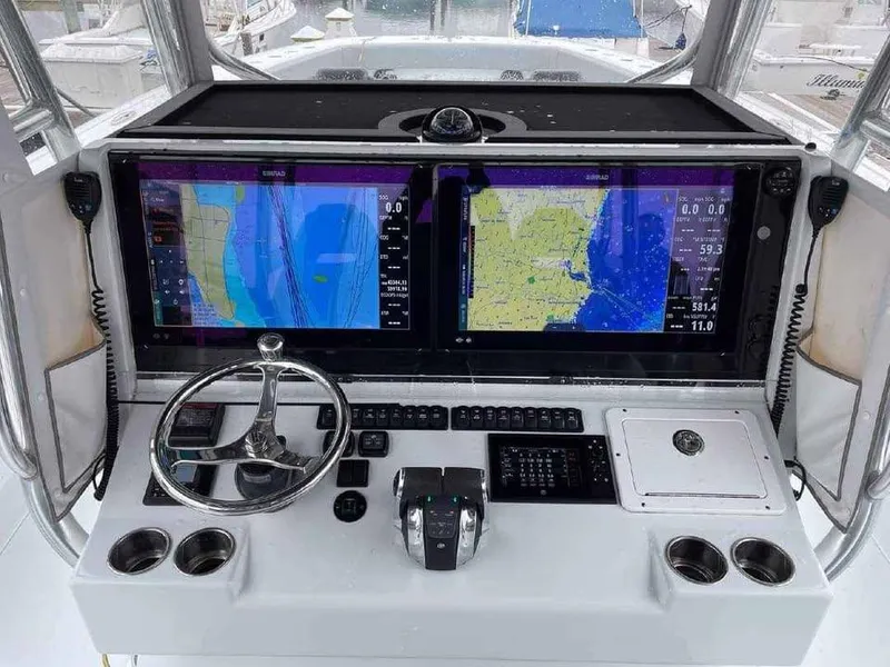 Slide: The Image of Helm of 2020 Freeman 42 LR boat with dual navigation screens and controls. - 4