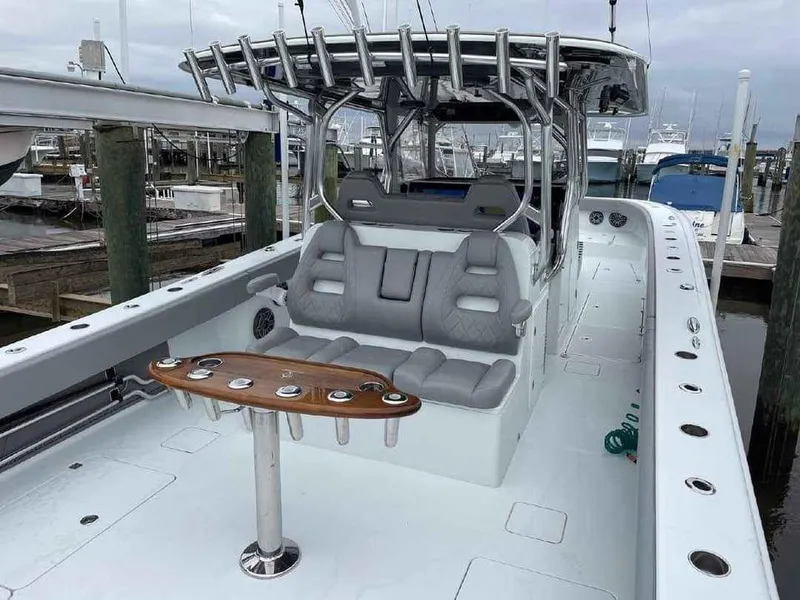 Slide: The Image of 2020 Freeman 42 LR boat with seating and rod holders at a marina. - 8