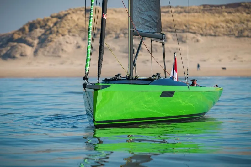 Slide: The Image of 2026 Saffier 24 Lite sailboat with vibrant green hull on calm water. - 7