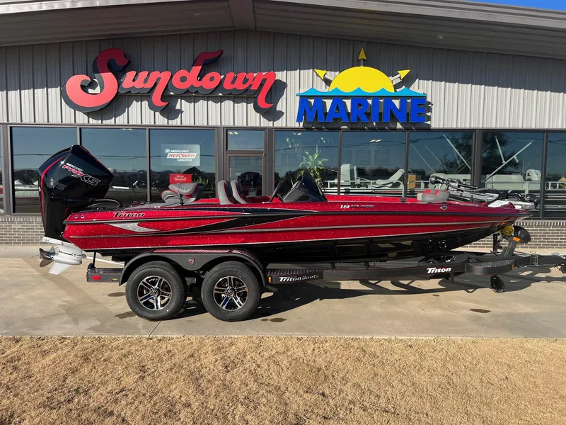 Slide: The Image of 2024 Triton 19 TrX Patriot boat displayed at Sundown Marine dealership. - 1