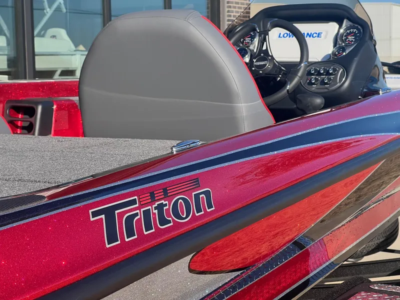 Slide: The Image of 2024 Triton 19 TrX Patriot boat, close-up of red exterior and cockpit. - 11