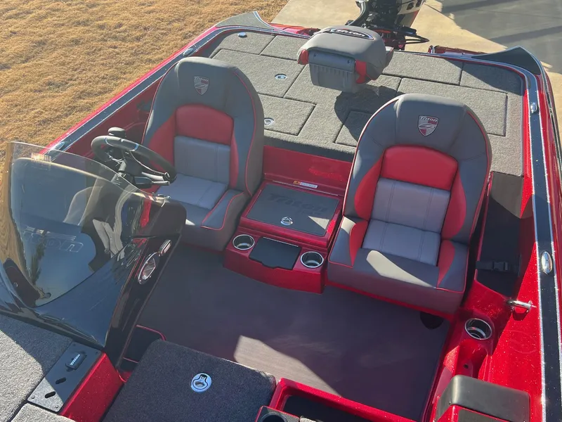 Slide: The Image of 2024 Triton 19 TrX Patriot boat interior with red and gray seats. - 16