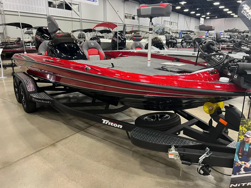 Slide: The Image of 2024 Triton 19 TrX Patriot bass boat on display in showroom. - 2