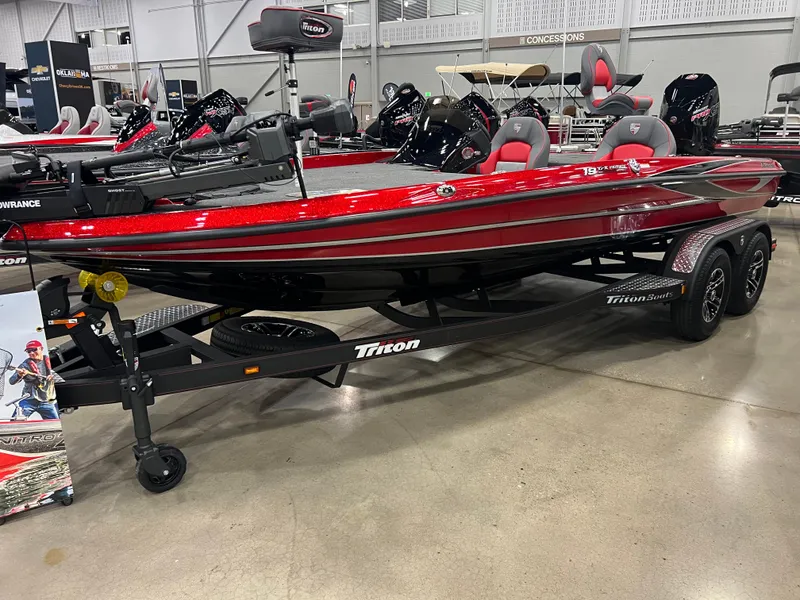 Slide: The Image of 2024 Triton 19 TrX Patriot bass boat on display in showroom. - 3