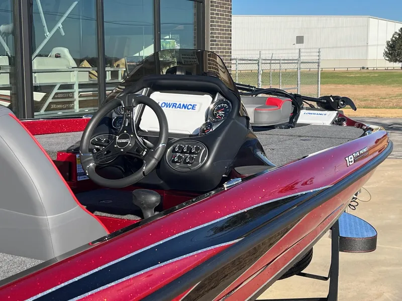 Slide: The Image of 2024 Triton 19 TrX Patriot bass boat with advanced navigation system. - 7
