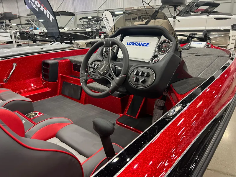 Slide: The Image of 2024 Triton 19 TrX Patriot boat interior with Lowrance electronics and red accents. - 8