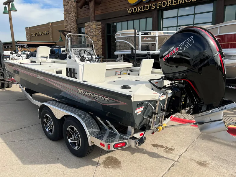 Slide: The Image of 2024 Ranger RB200 boat with Mercury engine on a trailer, displayed outdoors. - 2