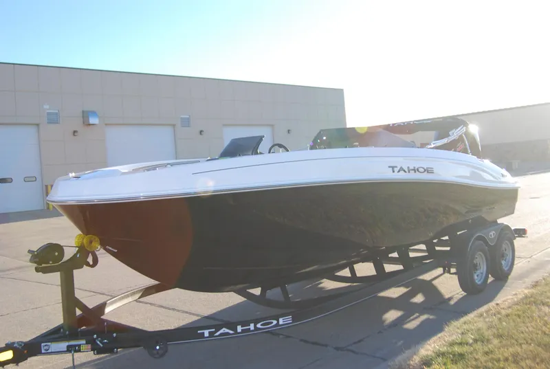 Slide: The Image of 2024 Tahoe T21 boat on trailer in front of industrial building. - 10