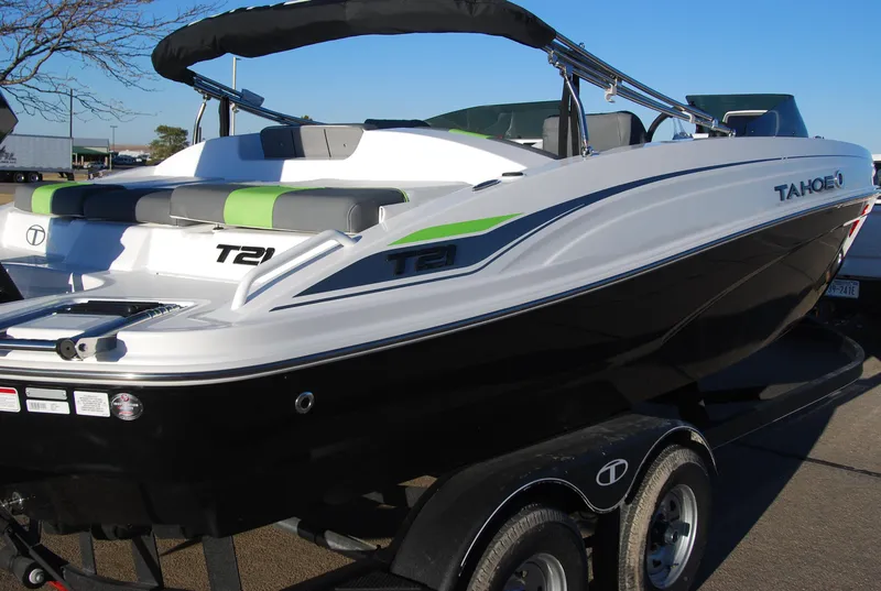 Slide: The Image of 2024 Tahoe T21 boat on trailer, black and white with green accents. - 3