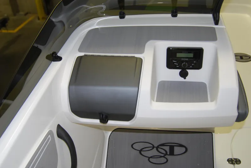 Slide: The Image of 2024 Tahoe T21 boat dashboard with control panel and storage compartment. - 6