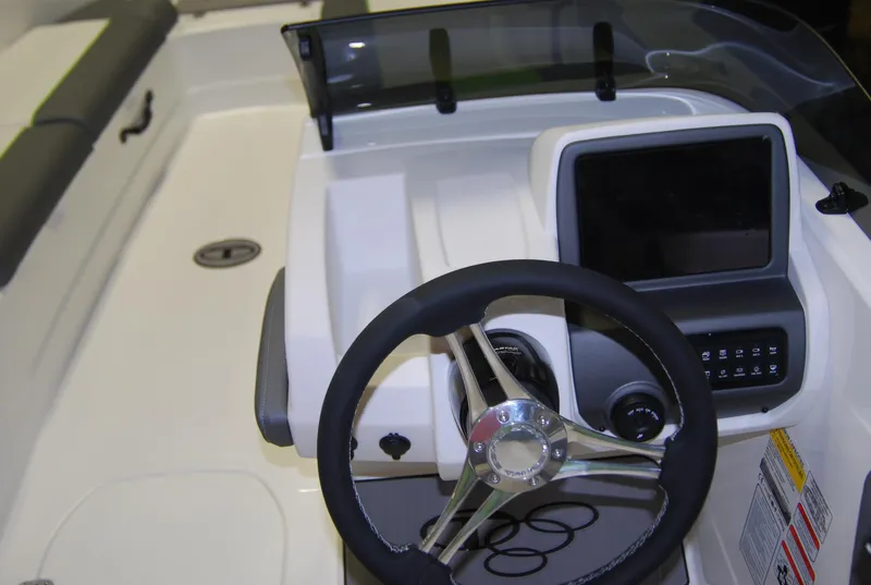 Slide: The Image of 2024 Tahoe T21 boat dashboard with steering wheel and control panel. - 7