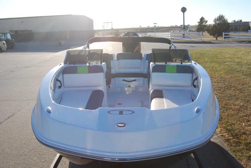 Slide: The Image of 2024 Tahoe T21 boat with spacious seating, docked outdoors. - 9