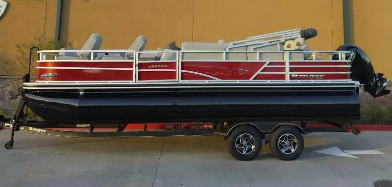 Slide: The Image of 2024 Ranger Reata 220FC pontoon boat on a trailer. - 1
