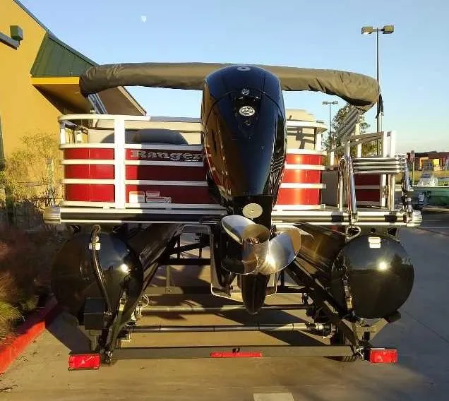 Slide: The Image of 2024 Ranger Reata 220FC pontoon boat with outboard motor, rear view. - 4