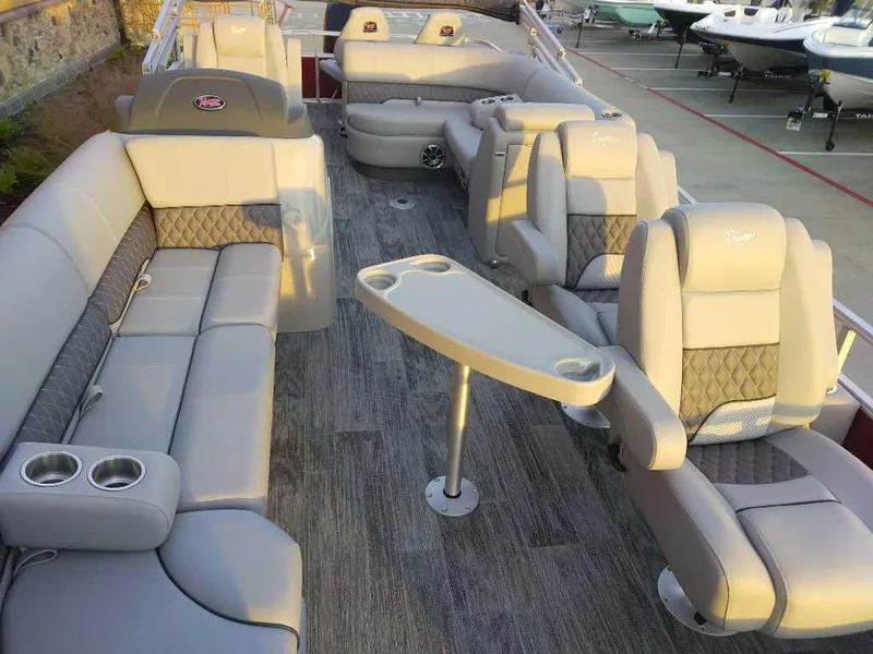 Slide: The Image of 2024 Ranger Reata 220FC boat interior with luxurious seating and table. - 6
