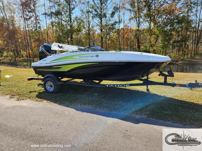 The Image of 2024 Tahoe T16 boat on trailer, parked outdoors near trees. - 0