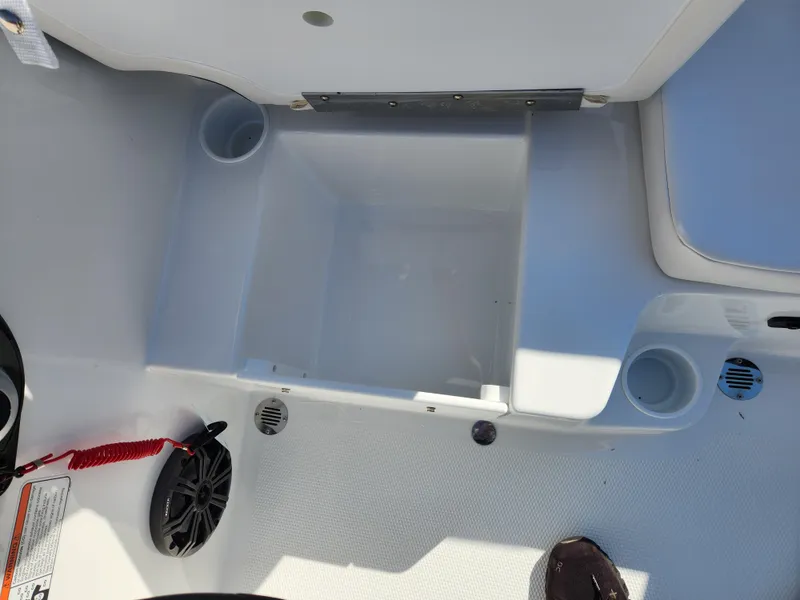 Slide: The Image of 2024 Tahoe T16 boat interior storage compartment with cup holders and safety lanyard. - 10