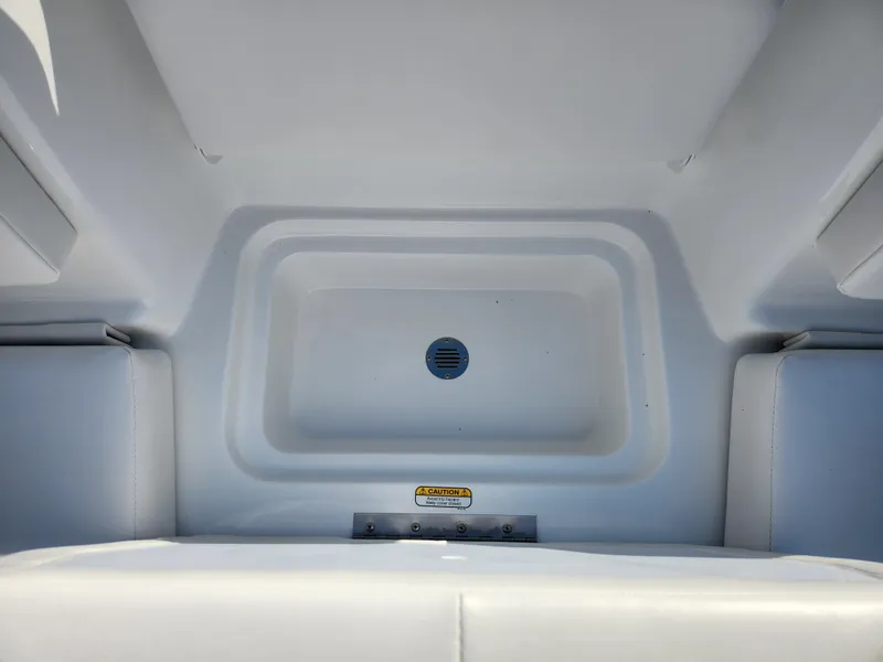 Slide: The Image of 2024 Tahoe T16 boat storage compartment with drain plug. - 11