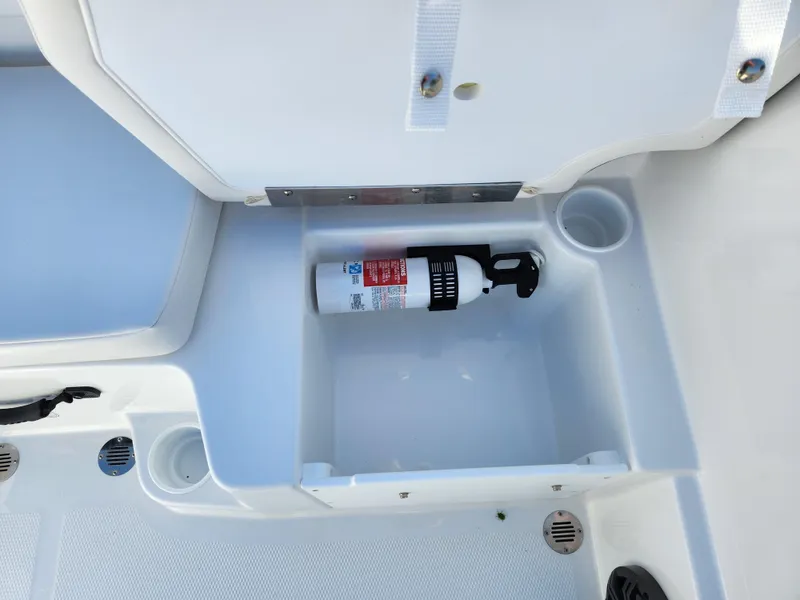 Slide: The Image of 2024 Tahoe T16 boat storage compartment with fire extinguisher. - 12