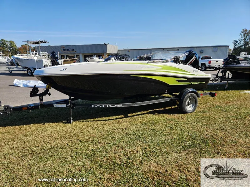 Slide: The Image of 2024 Tahoe T16 boat on trailer at dealership, green and black design. - 4