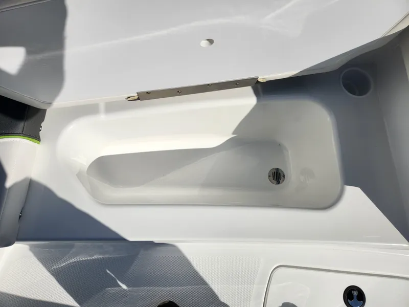 Slide: The Image of 2024 Tahoe T16 boat storage compartment with drain plug. - 8