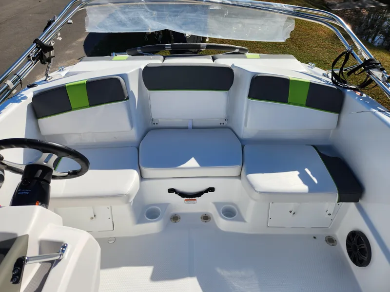 Slide: The Image of 2024 Tahoe T16 boat interior with white and green seating. - 9
