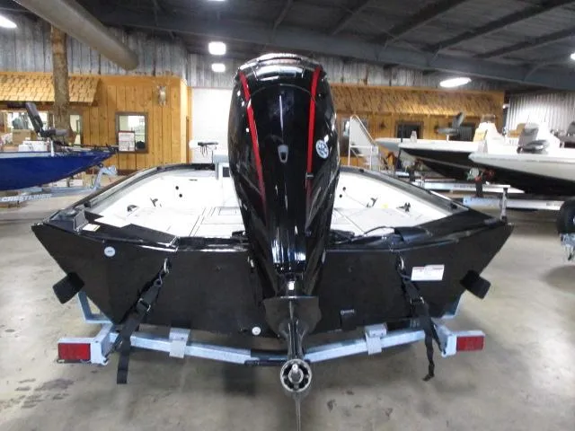 Slide: The Image of 2024 Crestliner 1800 Bay boat with outboard motor in a showroom. - 3