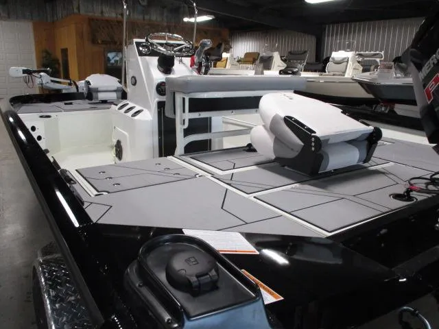 Slide: The Image of 2024 Crestliner 1800 Bay boat interior with seating and control console. - 4