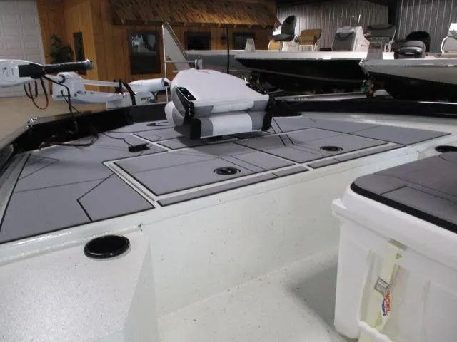 Slide: The Image of 2024 Crestliner 1800 Bay boat interior with seating and storage compartments. - 6