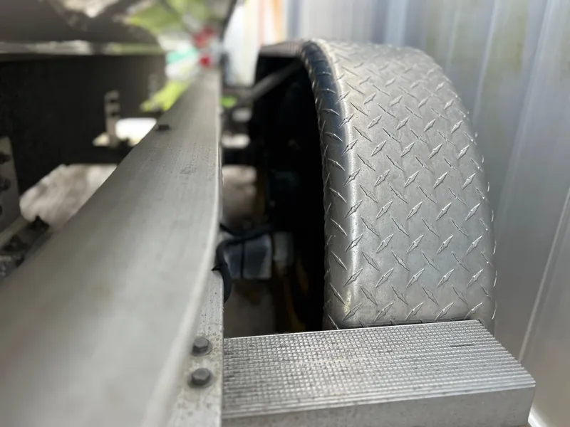 Slide: The Image of Close-up of 2020 Aquasport 244 Bay boat trailer wheel and fender. - 12